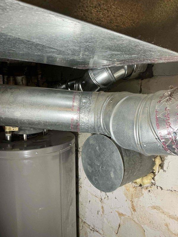 Completed installation of chimney liner system with new metallic flue pipe and rain cap mounted to existing masonry chimney structure. Replaced 70,000 BTU furnace and 2.5 ton air conditioning system with outdoor condenser positioned in right side yard, including humidifier installation and system reconnection. All mechanical permits obtained, ductwork configured and insulated, and system tested for proper operation upon completion.