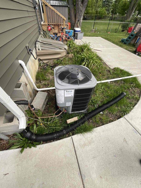 Conducted on-site assessment for complete central air conditioning system replacement. Evaluated existing Payne brand outdoor condenser unit and indoor air handling equipment, noting absence of high voltage electrical line from breaker panel to exterior condenser location. Documented current system configuration including refrigerant line routing, PVC condensate drain installation, and equipment placement in residential backyard setting. Reviewed indoor mechanical room containing water heater and HVAC components to determine compatibility requirements for new system installation. Provided comprehensive replacement estimate including necessary electrical infrastructure upgrades and discussed available financing options with homeowner.