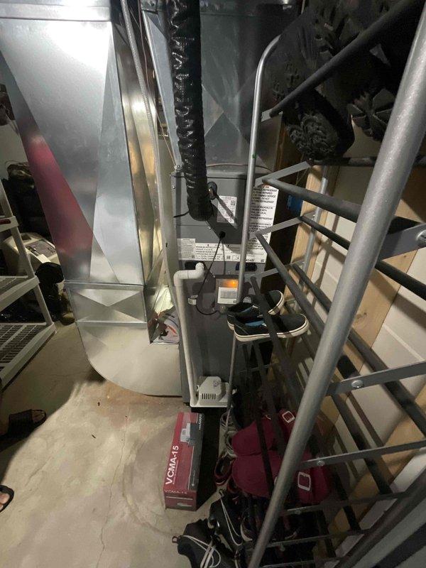 Conducted on-site assessment for complete central air conditioning system replacement. Evaluated existing Payne brand outdoor condenser unit and indoor air handling equipment, noting absence of high voltage electrical line from breaker panel to exterior condenser location. Documented current system configuration including refrigerant line routing, PVC condensate drain installation, and equipment placement in residential backyard setting. Reviewed indoor mechanical room containing water heater and HVAC components to determine compatibility requirements for new system installation. Provided comprehensive replacement estimate including necessary electrical infrastructure upgrades and discussed available financing options with homeowner.