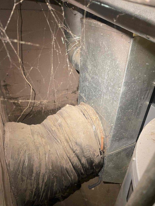 Conducted on-site assessment for new air conditioner installation at owner-occupied residence with no existing cooling system. Evaluated existing ductwork in basement utility area, noting aged flexible duct with visible wear and dust accumulation, and documented dimensions of existing metal panels and components. Photographed current conditions including ductwork configuration and measurements to develop comprehensive installation estimate for complete AC system as requested for expedited installation timeline.