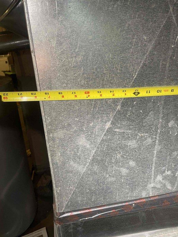 Conducted on-site assessment for new air conditioner installation at owner-occupied residence with no existing cooling system. Evaluated existing ductwork in basement utility area, noting aged flexible duct with visible wear and dust accumulation, and documented dimensions of existing metal panels and components. Photographed current conditions including ductwork configuration and measurements to develop comprehensive installation estimate for complete AC system as requested for expedited installation timeline.