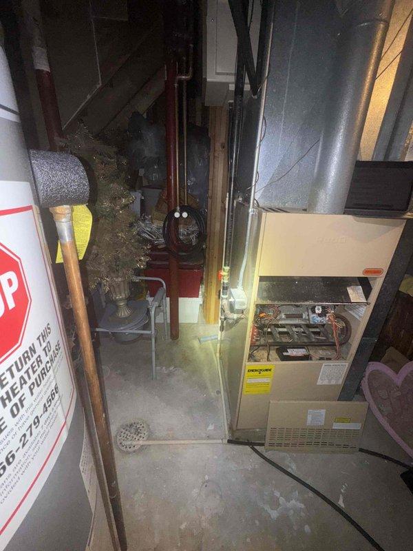 Conducted comprehensive assessment of existing HVAC system in residential basement for full furnace and air conditioning replacement estimate. Evaluated current beige furnace unit, existing ductwork configuration including metallic supply ducts and white flexible return ducting, and overall system layout to determine equipment specifications and installation requirements for complete system replacement scheduled within the month.