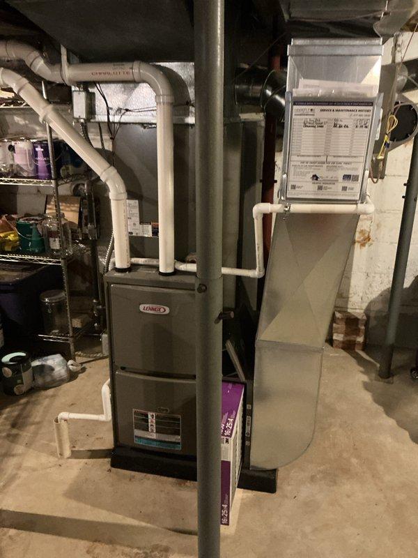 Performed annual HVAC maintenance on Lennox forced-air system, including inspection of evaporative humidifier pad filter which showed dust accumulation and discoloration. Documented existing system condition and noted requirement for 45-foot by 4-inch chimney liner installation to be coordinated with future service work.
