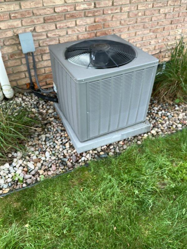 Completed annual air conditioning maintenance on residential condensing unit. Performed comprehensive system inspection including electrical connections, refrigerant lines, and condenser coil examination. Unit found in good operating condition with proper airflow through louvered panels and fan assembly functioning normally.