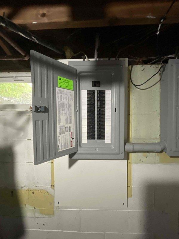 Completed site assessment for air conditioner replacement estimate at residential property. Inspected existing HVAC system including electrical panel, ductwork configuration, and mechanical space layout to determine equipment compatibility and installation requirements. Documented current system conditions through photographs of electrical service panel with circuit breakers, rectangular metal ductwork with flexible connections, and unfinished utility area with exposed framing to provide accurate replacement specifications and identify any necessary modifications for new equipment installation.