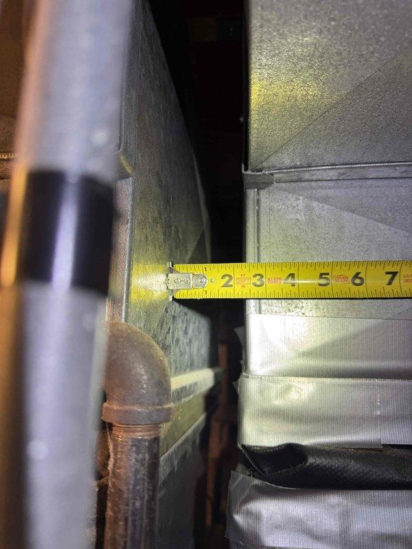 Conducted on-site assessment for complete air conditioning system replacement at residential property. Evaluated existing 35-year-old AC unit that was no longer operational and affecting cooling throughout entire home. Documented existing system configuration, measured clearances and spatial requirements in mechanical area, and photographed current equipment layout including ductwork connections, refrigerant line routing, and available installation space. Prepared comprehensive quote for new Lennox air conditioning system replacement per customer request.