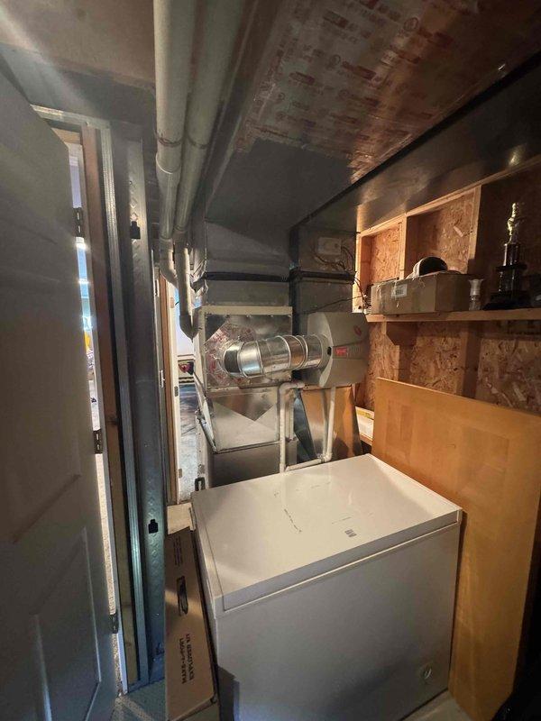 Conducted on-site assessment for complete air conditioning system replacement at residential property. Evaluated existing 35-year-old AC unit that was no longer operational and affecting cooling throughout entire home. Documented existing system configuration, measured clearances and spatial requirements in mechanical area, and photographed current equipment layout including ductwork connections, refrigerant line routing, and available installation space. Prepared comprehensive quote for new Lennox air conditioning system replacement per customer request.