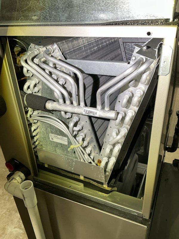 Performed routine Air Care Cooling maintenance on residential HVAC system. Accessed evaporator coil assembly, inspected A-frame coil configuration and serpentine tubing for proper condition, verified drain pan and condensate line functionality, and documented system components with photographic records. All equipment operating within normal parameters with no deficiencies noted.