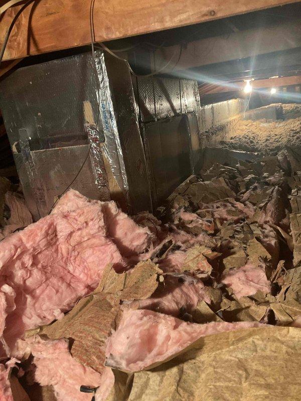 Provided comprehensive estimate for air conditioning system replacement on 35-year-old attic-mounted unit. Property utilizes natural gas boiler for heating with separate A/C system located in attic space. Assessed existing equipment condition, ductwork configuration, and crawl space conditions including deteriorated insulation materials and debris accumulation throughout service area. Documented current system specifications and structural considerations for replacement installation planning.