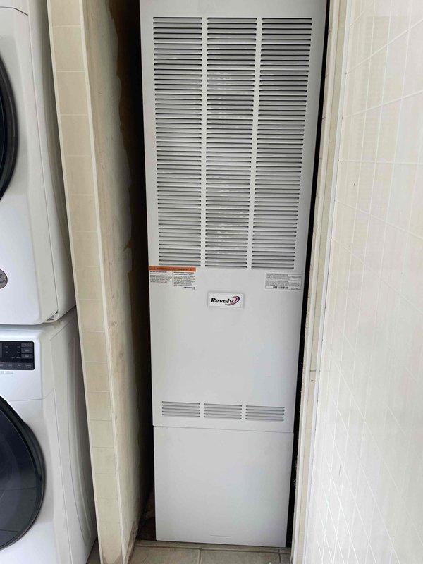 Completed full HVAC system installation including a Revolv 70,000 BTU vertical furnace installed in interior alcove and Lennox 2-ton air conditioning condensing unit positioned on exterior pad on left side of residence. Obtained mechanical and electrical permits prior to installation, ran refrigerant lines and electrical connections between indoor and outdoor units, installed condensate drain line with exterior PVC discharge, and mounted electrical disconnect box at outdoor unit. All equipment tested, commissioned, and left in operational condition with proper airflow verified at both indoor and outdoor units.