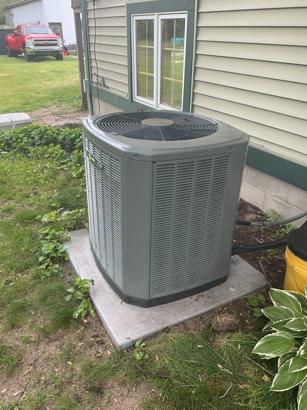 # HVAC Service Completion Report

Responded to no-cooling complaint on 10-year-old Trane XR13 air conditioning system at rental property. Upon arrival, performed visual inspection of outdoor condensing unit and discovered evidence of rodent infestation. Found mouse nesting materials inside cabinet and confirmed multiple electrical wires had been chewed and damaged by mice, preventing system operation.

Documented existing conditions with photographs showing unit exterior, nameplate data, and installation location. Removed access panels to assess full extent of damage to wiring harness and internal components. Cleared nesting materials and debris from unit interior to prevent further contamination and evaluate all affected circuits.

Assessed damaged wiring throughout control circuit and determined extent of repairs needed to restore system functionality. Due to age of equipment and severity of rodent damage, discussed repair options with property owner to determine most cost-effective 