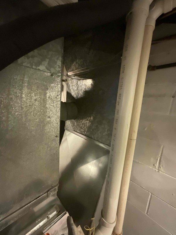 Conducted on-site evaluation for replacement of 30-year-old residential air conditioning system. Inspected existing HVAC equipment in basement mechanical room, including furnace, ductwork configuration, and condensate drainage system. Documented current system layout with photographic evidence showing aged infrastructure, existing duct connections with moisture accumulation, and available installation space. Provided comprehensive replacement quote for new air conditioning unit to address equipment obsolescence and ensure reliable cooling performance.