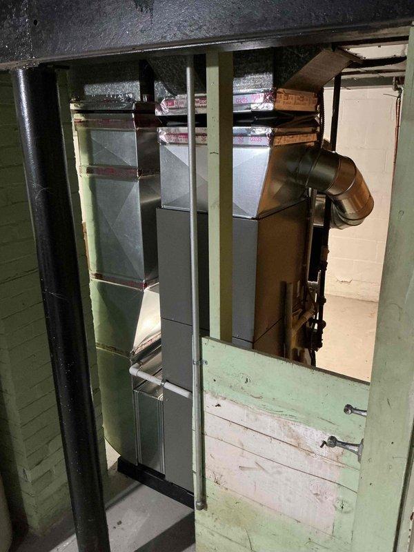Completed full HVAC system installation including a Lennox 45,000 BTU furnace, 1.5-ton air conditioning unit with rear discharge configuration, and integrated humidifier system in basement utility area. Installed all necessary ductwork, PVC condensate drainage lines, electrical connections, and venting per mechanical permit specifications, with system positioned on protective base pad and all components properly secured and interconnected for optimal airflow and efficiency.