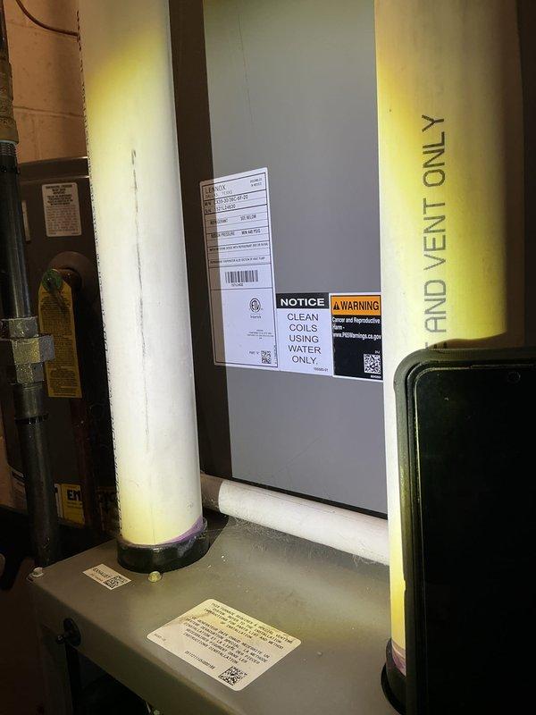Completed scheduled ComfortGuard Maintenance visit on HVAC system. Performed comprehensive inspection of air handling unit and associated components in mechanical room. Replaced accordion-style pleated air filter with new unit per maintenance protocol. Verified all manufacturer labels and safety notices remain legible, including coil cleaning instructions and warning stickers. Inspected refrigerant line insulation for integrity; yellow foam insulation on vertical piping confirmed secure and intact. System components operating within normal parameters with no issues identified during service visit.