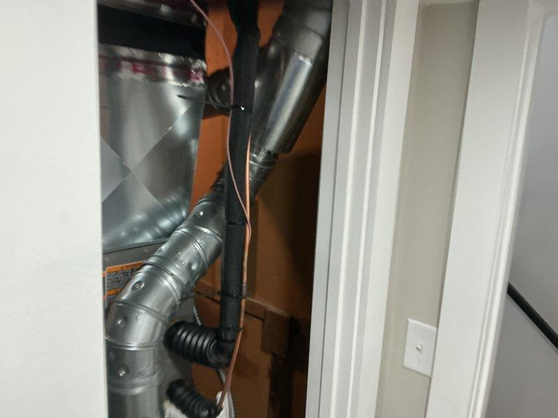 Completed full HVAC system installation including a 70,000 BTU furnace and 2-ton air conditioning unit. Installed new electrical circuit to support the system, routed galvanized metal ductwork through utility closet with multiple elbows and connections, and integrated flexible discharge piping. Obtained mechanical and electrical permits prior to installation, documented completed work with photographs, and verified all components were properly installed and operational.