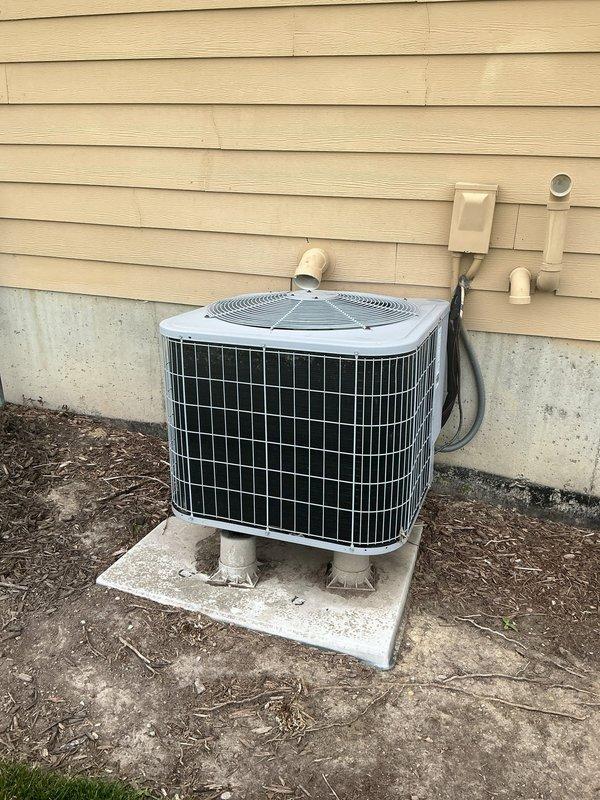 Responded to service call for 15-year-old central air conditioning system experiencing excessive noise and extended cooling cycles. Upon arrival, performed comprehensive inspection of outdoor condenser unit. Found significant debris accumulation around base of unit and beneath equipment, including leaves, twigs, and organic matter restricting airflow. Cleared all debris from around condenser base and concrete pad. Inspected refrigerant line connections, electrical connections, and condensate drainage system. Verified proper operation of condenser fan motor and compressor. System tested successfully after cleaning, with improved airflow and reduced noise levels. Unit now cooling efficiently within normal parameters.
