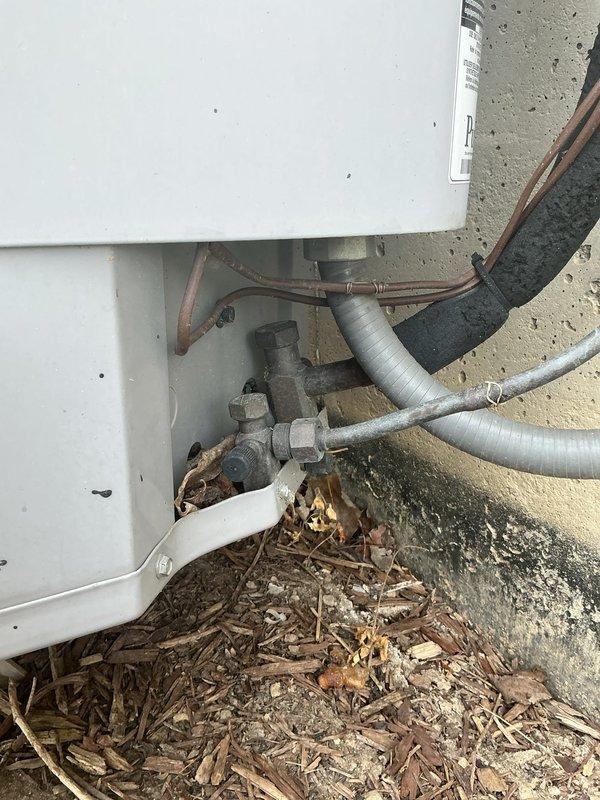 Responded to service call for 15-year-old central air conditioning system experiencing excessive noise and extended cooling cycles. Upon arrival, performed comprehensive inspection of outdoor condenser unit. Found significant debris accumulation around base of unit and beneath equipment, including leaves, twigs, and organic matter restricting airflow. Cleared all debris from around condenser base and concrete pad. Inspected refrigerant line connections, electrical connections, and condensate drainage system. Verified proper operation of condenser fan motor and compressor. System tested successfully after cleaning, with improved airflow and reduced noise levels. Unit now cooling efficiently within normal parameters.