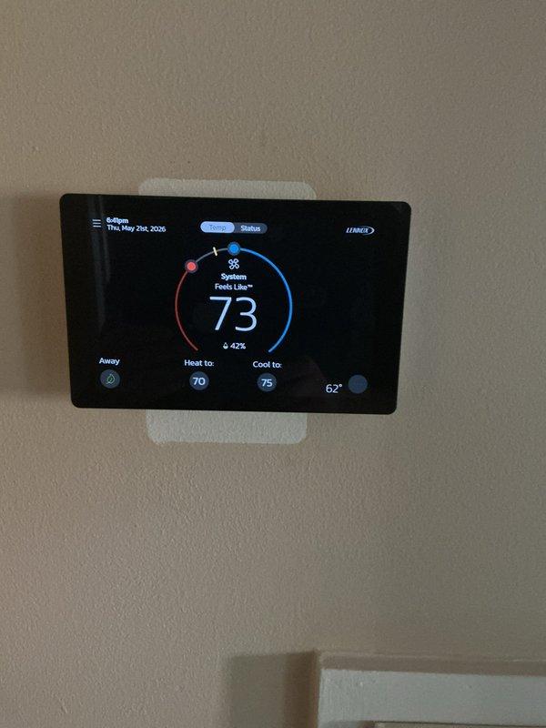 Responded to no cooling call on residential central air conditioning system. Upon arrival, found Lennox thermostat displaying but system not responding to cooling demand. Verified thermostat was calling for cooling with setpoint at 75°F and indoor temperature reading 73°F. Inspected outdoor Lennox condenser unit and found no power to compressor or condenser fan motor. Checked electrical disconnect at exterior wall and discovered tripped breaker. Reset breaker and restored power to condensing unit. System started successfully with compressor and condenser fan operating normally. Verified proper airflow through condenser coils and confirmed adequate clearance around unit despite surrounding landscaping. Monitored system operation through complete cooling cycle. Thermostat responded appropriately to temperature changes and system cycled off at setpoint. Advised homeowner to monitor for any repeat occurrences that may indicate underlying electrical issue requiring further diagnosis.