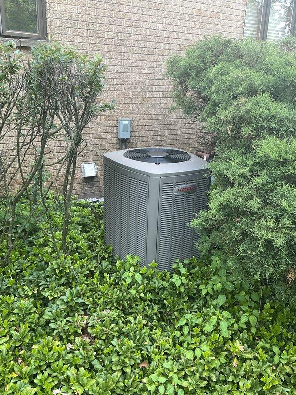 Responded to no cooling call on residential central air conditioning system. Upon arrival, found Lennox thermostat displaying but system not responding to cooling demand. Verified thermostat was calling for cooling with setpoint at 75°F and indoor temperature reading 73°F. Inspected outdoor Lennox condenser unit and found no power to compressor or condenser fan motor. Checked electrical disconnect at exterior wall and discovered tripped breaker. Reset breaker and restored power to condensing unit. System started successfully with compressor and condenser fan operating normally. Verified proper airflow through condenser coils and confirmed adequate clearance around unit despite surrounding landscaping. Monitored system operation through complete cooling cycle. Thermostat responded appropriately to temperature changes and system cycled off at setpoint. Advised homeowner to monitor for any repeat occurrences that may indicate underlying electrical issue requiring further diagnosis.