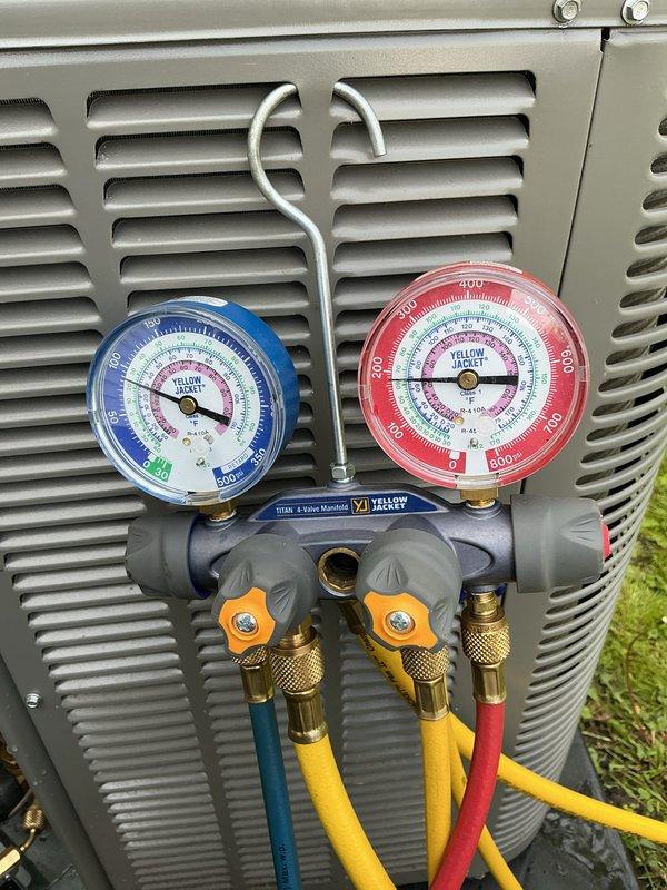 Performed ACM5 preventive maintenance on outdoor air conditioning unit. Connected manifold gauges to service ports and verified refrigerant pressures within manufacturer specifications. Documented equipment identification tag and electrical connections for service records.