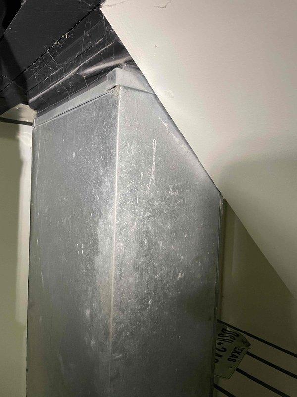 Responded to service call for non-functional central air conditioning system at condominium property. Upon arrival, confirmed customer reports of hissing sounds and refrigerant leakage from outdoor condensing unit during operation, resulting in complete loss of cooling capacity and diminished airflow. Conducted comprehensive system evaluation of 4-year-old AC system, including inspection of indoor air handler unit located in attic space and assessment of refrigerant lines. Documented existing equipment condition through photographic evidence showing air handler installation and ductwork configuration. Determined system had sustained refrigerant leak rendering unit inoperable and unable to maintain conditioned space temperatures. Provided detailed replacement estimate for complete HVAC system replacement, including removal of failed equipment and installation of new air conditioning system to restore climate control functionality to the residence.