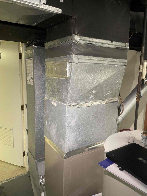 Responded to service call for non-functional central air conditioning system at condominium property. Upon arrival, confirmed customer reports of hissing sounds and refrigerant leakage from outdoor condensing unit during operation, resulting in complete loss of cooling capacity and diminished airflow. Conducted comprehensive system evaluation of 4-year-old AC system, including inspection of indoor air handler unit located in attic space and assessment of refrigerant lines. Documented existing equipment condition through photographic evidence showing air handler installation and ductwork configuration. Determined system had sustained refrigerant leak rendering unit inoperable and unable to maintain conditioned space temperatures. Provided detailed replacement estimate for complete HVAC system replacement, including removal of failed equipment and installation of new air conditioning system to restore climate control functionality to the residence.