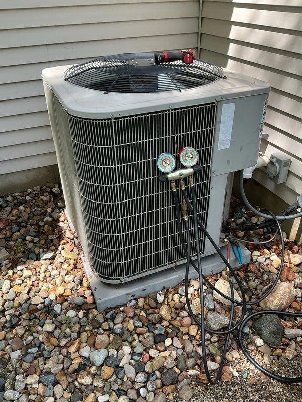 Performed annual preventative maintenance and system checkup on 14-year-old Bryant central air conditioning unit. Connected refrigerant manifold gauge set to outdoor condenser unit to measure and verify system pressures and refrigerant charge levels. All gauges indicated proper operating pressures within manufacturer specifications. Inspected condenser coil fins, fan assembly, and electrical connections. System confirmed operational with proper heating and cooling capability maintained.