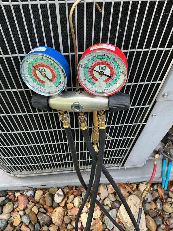 Performed annual preventative maintenance and system checkup on 14-year-old Bryant central air conditioning unit. Connected refrigerant manifold gauge set to outdoor condenser unit to measure and verify system pressures and refrigerant charge levels. All gauges indicated proper operating pressures within manufacturer specifications. Inspected condenser coil fins, fan assembly, and electrical connections. System confirmed operational with proper heating and cooling capability maintained.