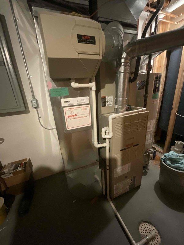 Completed comprehensive estimate for full HVAC system replacement including furnace and air conditioning unit. Both existing Lennox systems are approximately 21 years old and nearing end of serviceable life. Customer requested quote for proactive replacement planned for summer installation, with preference to continue with Lennox brand equipment. Assessed current basement installation including furnace, humidifier, ductwork configuration, and condensate drainage system. Documented existing equipment specifications, electrical panel location, and available workspace for future installation. Photographed current system layout showing furnace unit, wall-mounted humidifier with PVC connections, metallic supply and return ductwork, and overall mechanical room configuration. Provided information regarding available promotions as requested.