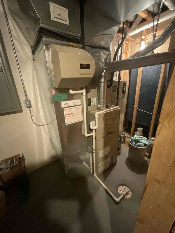 Completed comprehensive estimate for full HVAC system replacement including furnace and air conditioning unit. Both existing Lennox systems are approximately 21 years old and nearing end of serviceable life. Customer requested quote for proactive replacement planned for summer installation, with preference to continue with Lennox brand equipment. Assessed current basement installation including furnace, humidifier, ductwork configuration, and condensate drainage system. Documented existing equipment specifications, electrical panel location, and available workspace for future installation. Photographed current system layout showing furnace unit, wall-mounted humidifier with PVC connections, metallic supply and return ductwork, and overall mechanical room configuration. Provided information regarding available promotions as requested.
