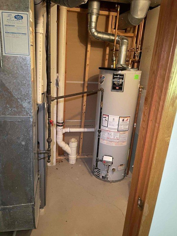 Completed full system estimate for 15-year-old air conditioning system requiring replacement due to confirmed evaporator coil leak. Assessed existing outdoor condensing unit, indoor air handler installation in utility room, refrigerant line set routing along exterior wall, and electrical connections. Documented current system configuration including ductwork connections, condensate drainage via PVC piping, and equipment placement for replacement planning.