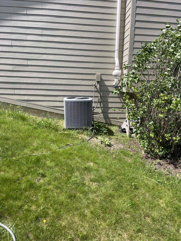 Completed full system estimate for 15-year-old air conditioning system requiring replacement due to confirmed evaporator coil leak. Assessed existing outdoor condensing unit, indoor air handler installation in utility room, refrigerant line set routing along exterior wall, and electrical connections. Documented current system configuration including ductwork connections, condensate drainage via PVC piping, and equipment placement for replacement planning.
