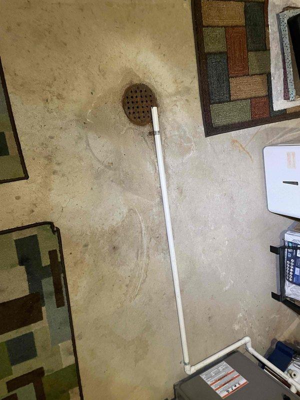 Conducted on-site evaluation of existing 16-year-old air conditioning system and 15-year-old water heater for replacement estimate. Documented current York furnace installation, water heater configuration with copper piping and gas connections, and existing PVC drainage and venting systems in basement mechanical room. Assessed equipment condition, measured installation area, photographed current setup including ductwork connections and utility configurations to provide comprehensive replacement proposal for both HVAC cooling system and water heating equipment.