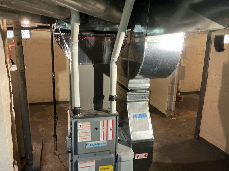 Completed installation of 2-ton air conditioning system with evaporator coil in basement mechanical room. Installed Daikin furnace unit with integrated coil, connected refrigerant lines with proper insulation, and established all necessary ductwork connections to existing infrastructure. Outdoor condensing unit positioned in rear yard per specifications, with all electrical and refrigerant connections completed, system tested and verified operational.