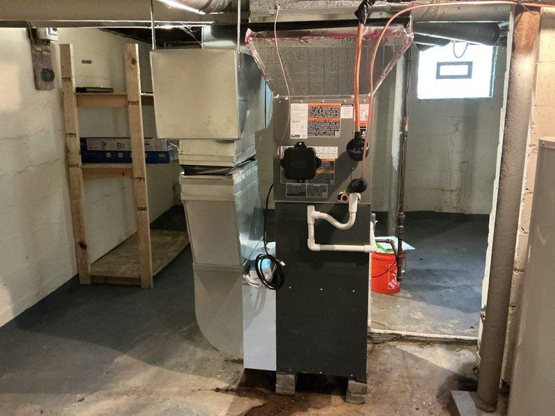 Completed installation of 2-ton air conditioning system with evaporator coil in basement mechanical room. Installed Daikin furnace unit with integrated coil, connected refrigerant lines with proper insulation, and established all necessary ductwork connections to existing infrastructure. Outdoor condensing unit positioned in rear yard per specifications, with all electrical and refrigerant connections completed, system tested and verified operational.