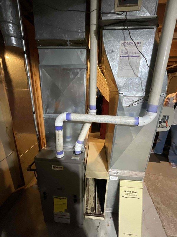 Responded to service call for non-cooling air conditioning system affecting entire residence. Evaluated 20-year-old HVAC system including existing Luxaire furnace, air handler with Space-gard air cleaner, and outdoor condensing unit. Documented current equipment configuration, ductwork layout, and basement installation setup with photographic evidence. Provided comprehensive replacement estimate options for aging air conditioning system that had reached end of serviceable life expectancy.