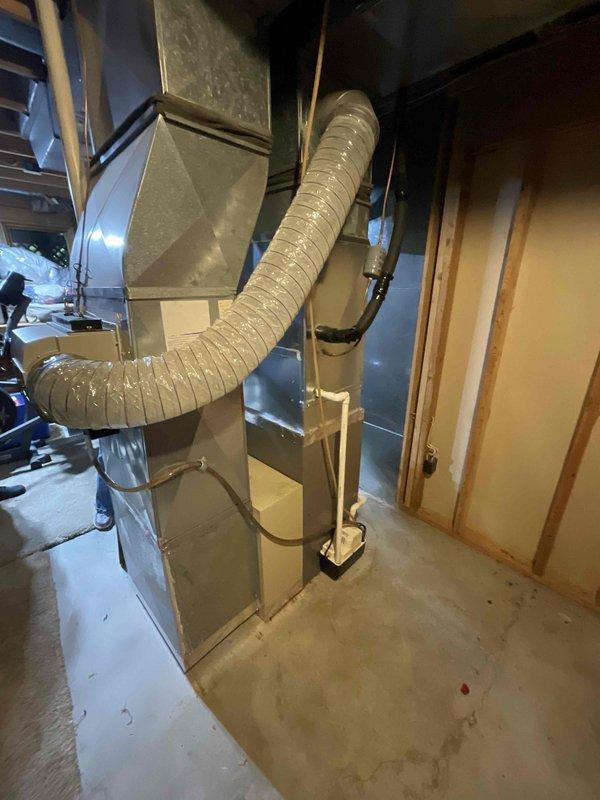 Responded to service call for non-cooling air conditioning system affecting entire residence. Evaluated 20-year-old HVAC system including existing Luxaire furnace, air handler with Space-gard air cleaner, and outdoor condensing unit. Documented current equipment configuration, ductwork layout, and basement installation setup with photographic evidence. Provided comprehensive replacement estimate options for aging air conditioning system that had reached end of serviceable life expectancy.