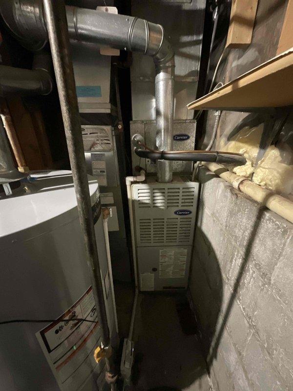 Provided comprehensive estimate for complete HVAC system replacement in basement location, including both furnace and air conditioning units. The existing Carrier air conditioning system was non-operational, and both units showed age-related deterioration requiring full replacement. Assessment included evaluation of existing ductwork, electrical service capacity at exterior meter location, and confined basement workspace constraints for proper equipment installation and future serviceability.
