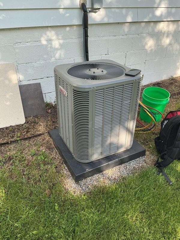 Completed scheduled air conditioning maintenance on residential condenser unit. Performed system diagnostics using manifold gauge set to check refrigerant pressures and verify proper operation. Unit was positioned on protective rubber pad as requested, with all components functioning within normal parameters at time of service.