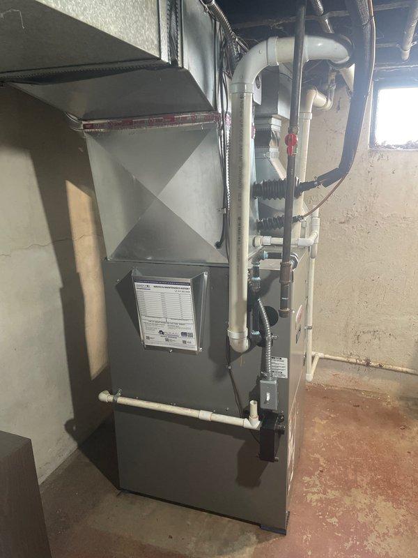 Completed installation of 2-ton air conditioning system with evaporator coil at rear location of residence. Reconnected all refrigerant lines, electrical connections, and condensate drainage to existing furnace system in basement utility room. Installed and programmed Sensi digital thermostat, verified system operation, and obtained all required mechanical and AC permits prior to installation.