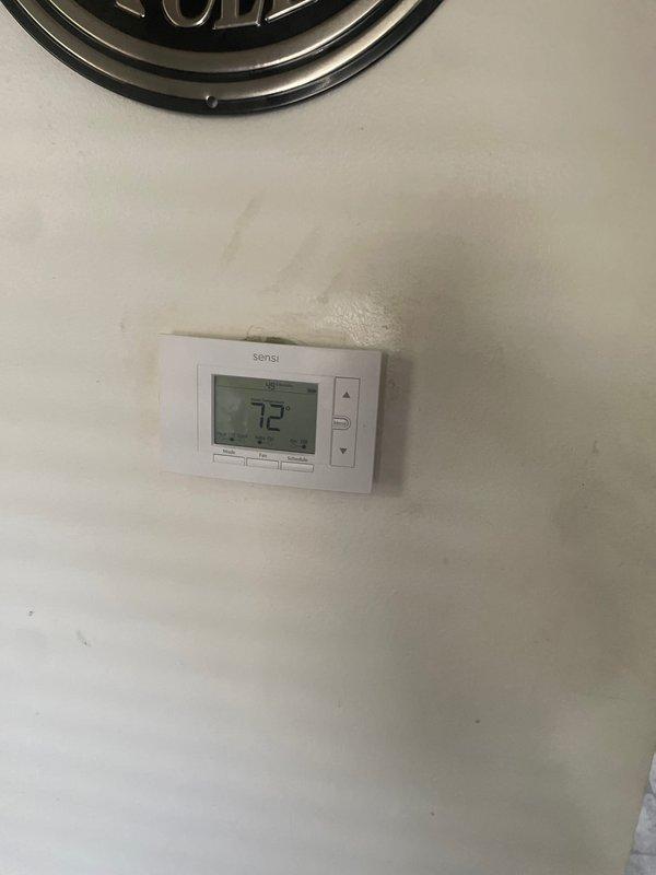 Completed installation of 2-ton air conditioning system with evaporator coil at rear location of residence. Reconnected all refrigerant lines, electrical connections, and condensate drainage to existing furnace system in basement utility room. Installed and programmed Sensi digital thermostat, verified system operation, and obtained all required mechanical and AC permits prior to installation.