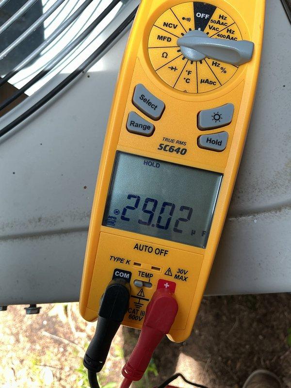 Performed standard air conditioning tune-up and system inspection. Conducted electrical diagnostics using digital multimeter, recording capacitor readings of 33.16 and 29.02 microfarads to verify proper compressor and fan motor operation. All measurements within acceptable parameters for continued system performance.