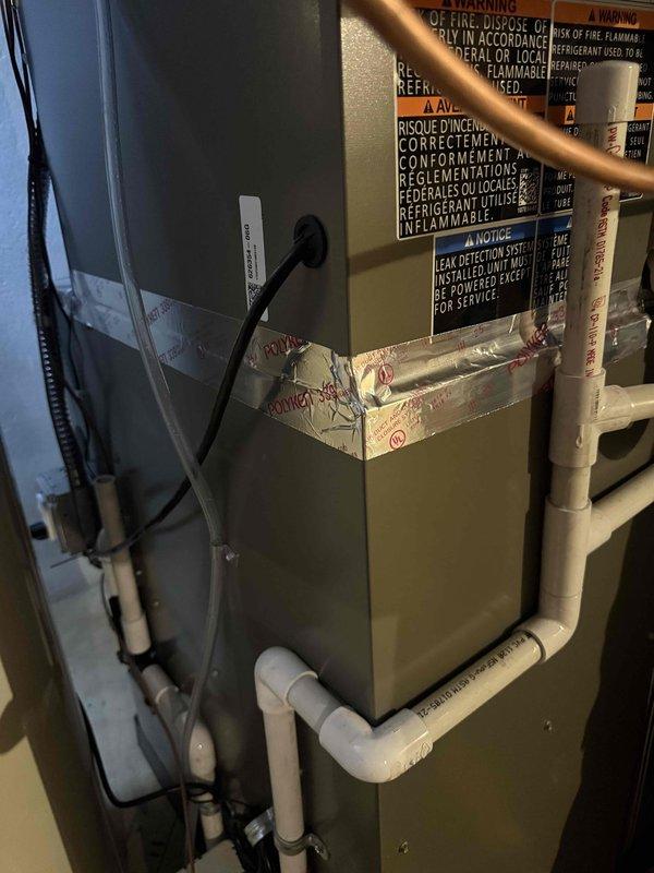 Completed callback service to seal gap between furnace and evaporator coil using metal tape to ensure proper air sealing and system efficiency. This follow-up addressed a minor installation detail from the recent complete HVAC system installation that included a 70,000 BTU furnace, 2-ton air conditioning unit, humidifier, liner, and new electrical circuit. System inspected and verified operating within manufacturer specifications with all components properly sealed and secured.