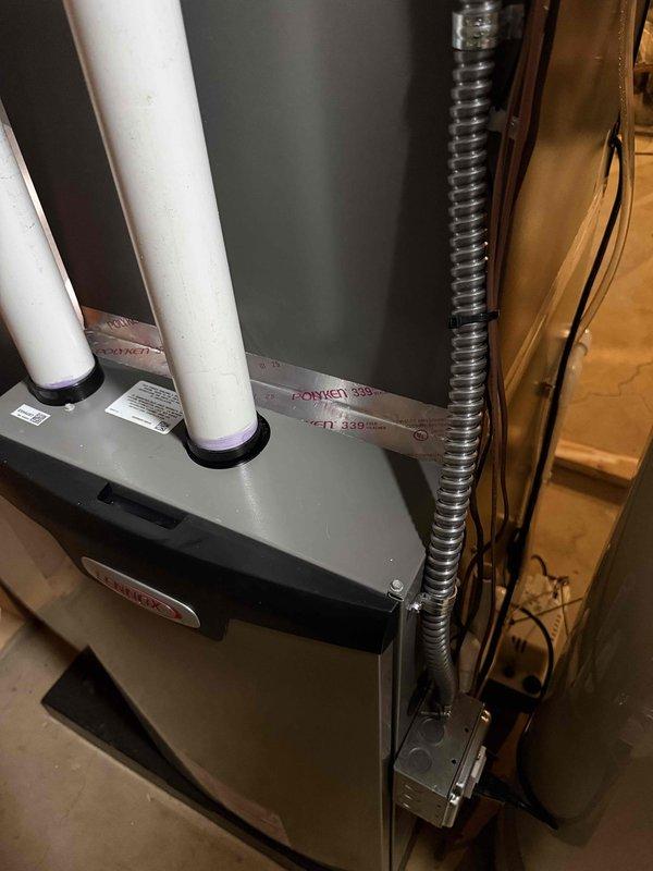 Completed callback service to seal gap between furnace and evaporator coil using metal tape to ensure proper air sealing and system efficiency. This follow-up addressed a minor installation detail from the recent complete HVAC system installation that included a 70,000 BTU furnace, 2-ton air conditioning unit, humidifier, liner, and new electrical circuit. System inspected and verified operating within manufacturer specifications with all components properly sealed and secured.