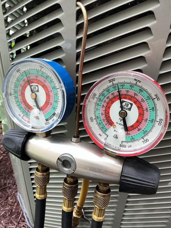Completed annual cooling maintenance on residential air conditioning system. Performed refrigerant pressure diagnostics using manifold gauge set on outdoor condenser unit, verifying system pressures and refrigerant charge levels within manufacturer specifications. All measurements indicated proper system operation with no issues identified.