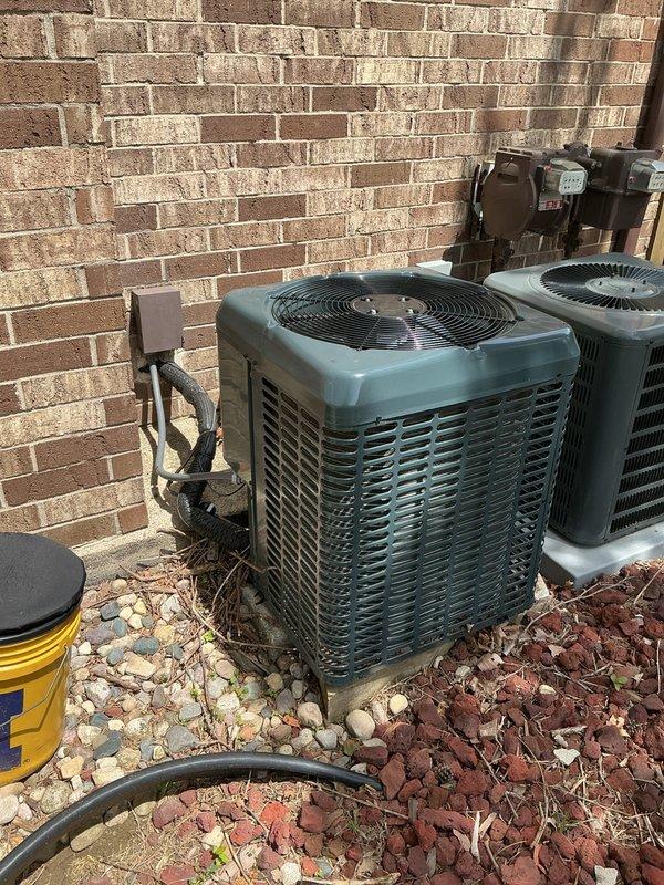 Responded to no cooling complaint on 8-year-old residential AC system. Upon arrival, inspected outdoor condenser units and indoor Luxaire furnace/air handler with access panel opened for diagnostic evaluation. Performed system assessment including electrical connections at disconnect box, refrigerant lines, and internal components. Documented equipment condition and configuration with photographic evidence showing dual outdoor units, ductwork, control boards, and wiring harness for service records.