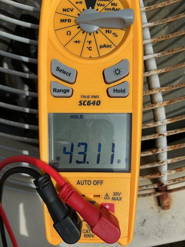Responded to heat pump system experiencing outdoor fan failure and coil freezing issues. Upon inspection, diagnosed failed dual run capacitor with readings of 43.11 and 49.18 MFD, both below manufacturer specifications, preventing condenser fan motor operation in both heating and cooling modes. Replaced defective capacitor, restored system to proper operation, and performed general assessment of 16-year-old furnace as requested.