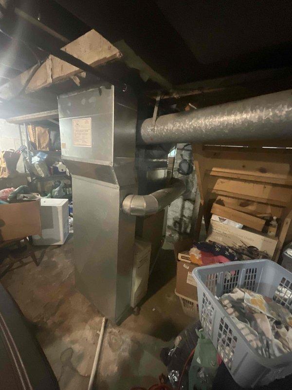 Completed estimate for replacement of existing basement-located natural gas furnace and air conditioning system. Current equipment is operational but age unknown. Assessed installation requirements for new HVAC system in basement utility area with existing ductwork infrastructure and verified clearance space for equipment replacement.