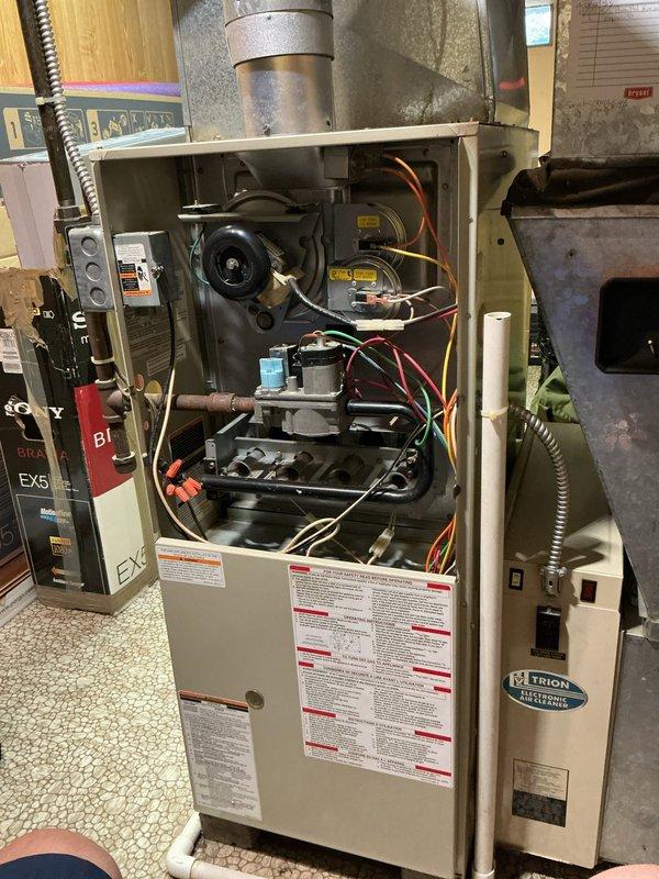 Responded to service call for furnace and hot water tank intermittently shutting off in basement location. Performed diagnostic inspection of aging HVAC system, including examination of furnace internal components, blower motor assembly, heat exchanger, electrical connections, and capacitor. Assessed ductwork connections and overall system operation to identify cause of equipment cycling issues.