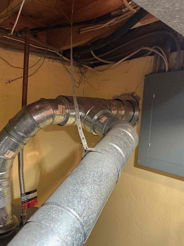 Responded to service call for furnace and hot water tank intermittently shutting off in basement location. Performed diagnostic inspection of aging HVAC system, including examination of furnace internal components, blower motor assembly, heat exchanger, electrical connections, and capacitor. Assessed ductwork connections and overall system operation to identify cause of equipment cycling issues.